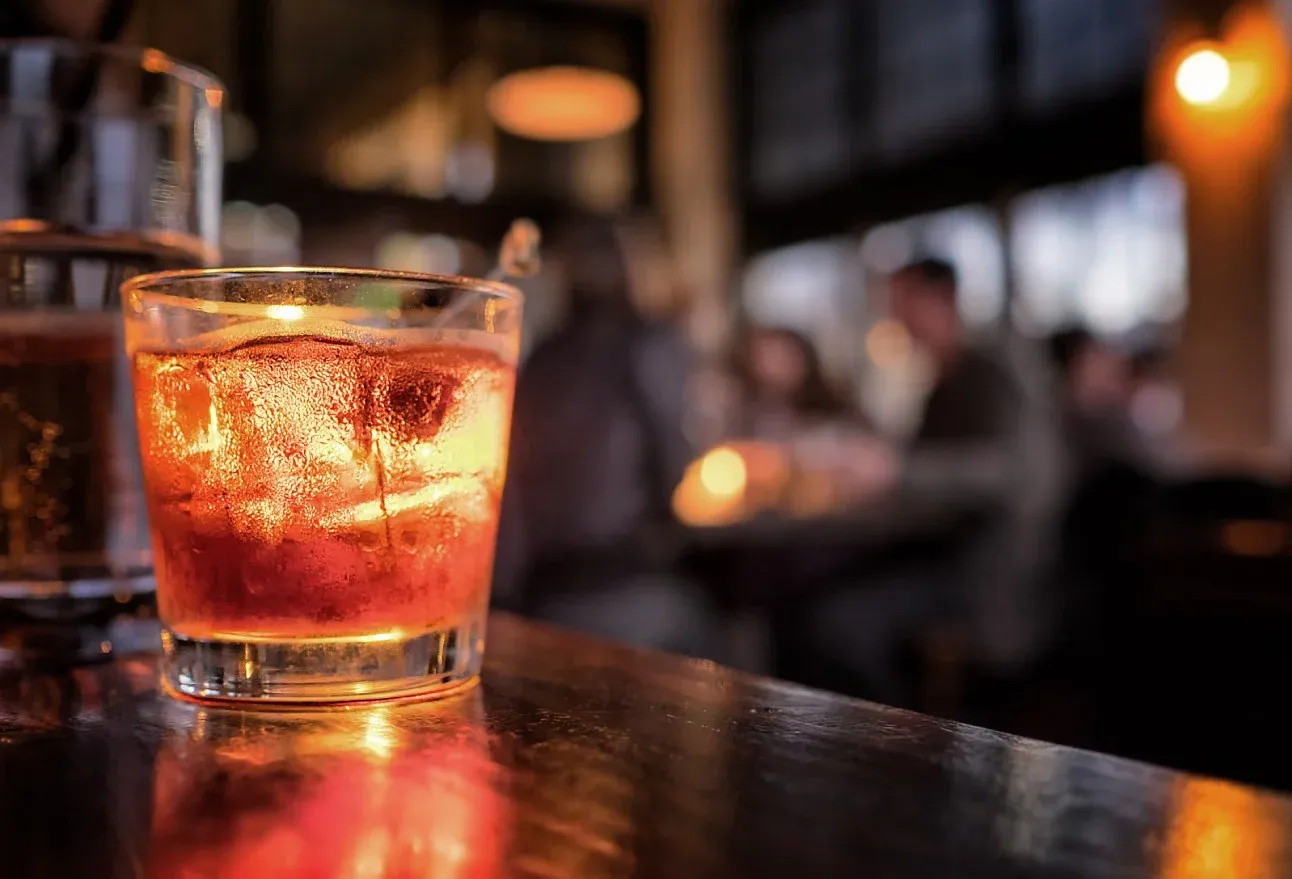 Drink med is på en bardisk i varm belysning